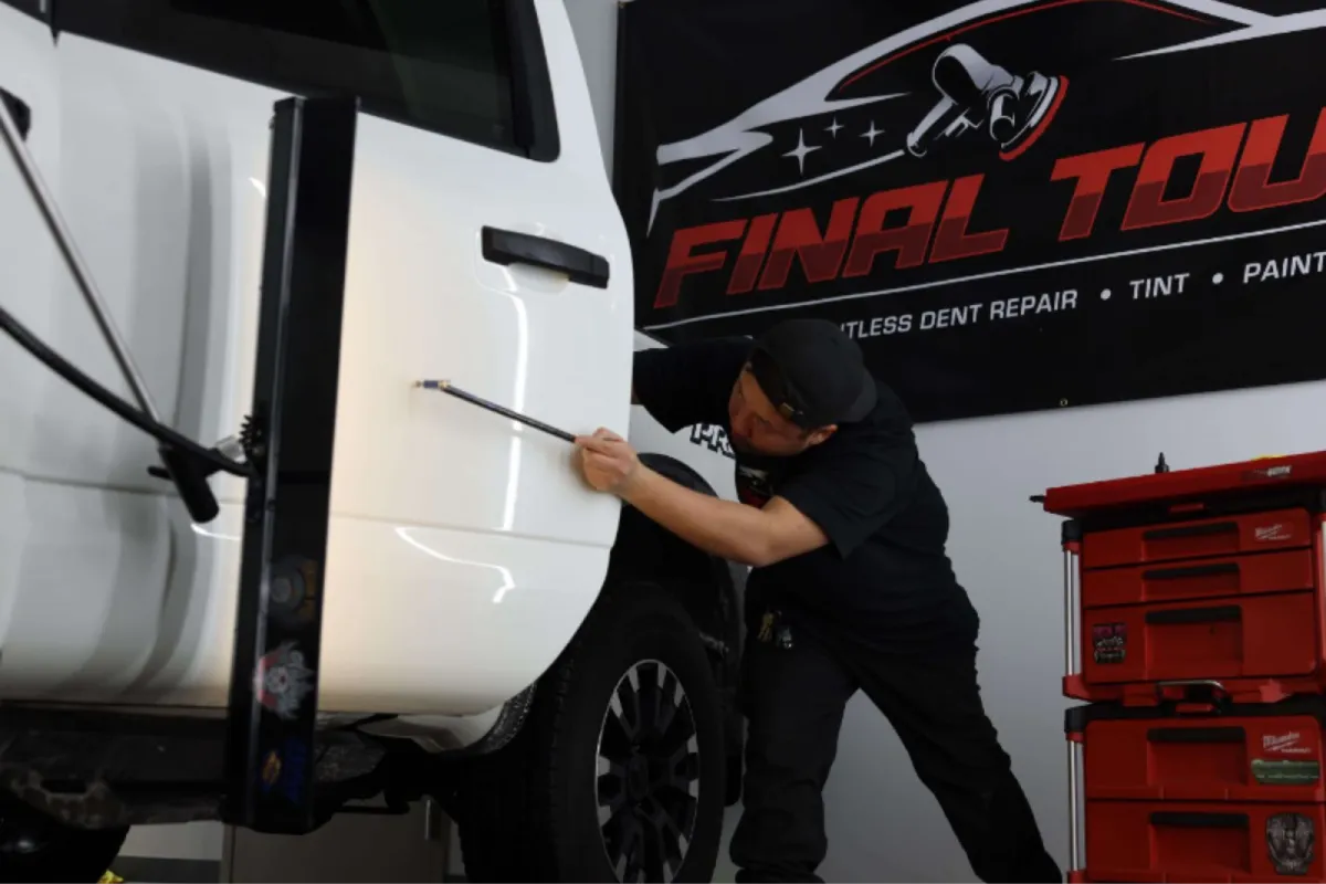 Technician performing professional auto protection service on a white truck.
