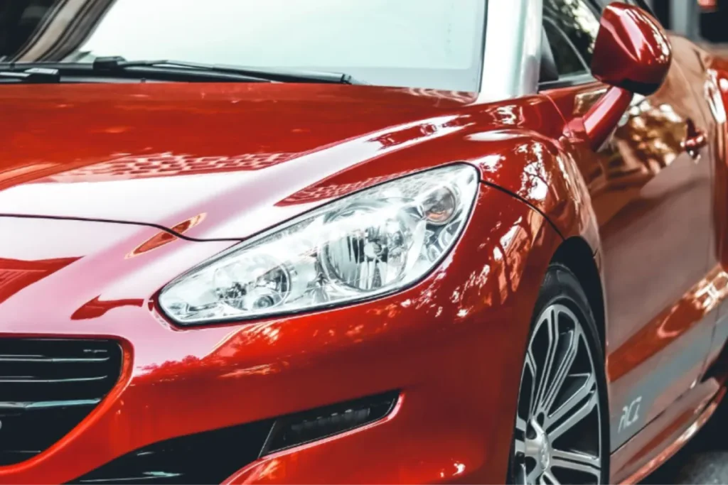 Red car with glossy finish showcasing professional auto protection.